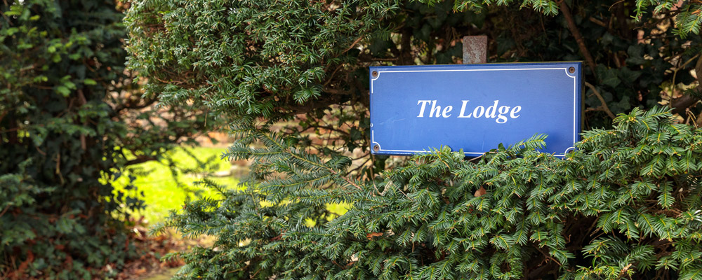 lodge name post among trees